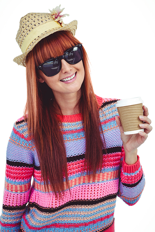 Attractive hipster woman holding a cup of coffee against white background