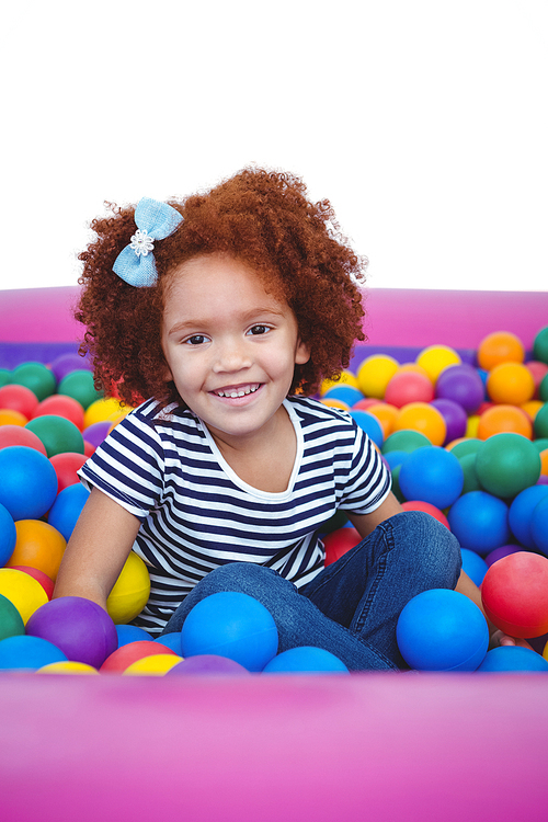 Cute smiling girl in sponge ball pool 