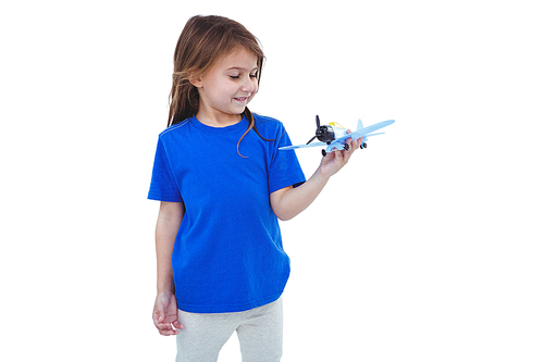 Cute girl playing with airplane on white screen