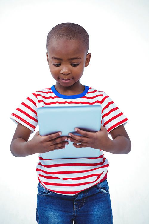 Standing boy using tablet on white screen