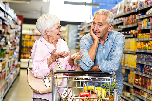 Senior couple shopping together in supermarket