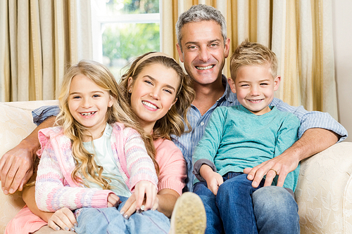 Happy family sitting together on a couch