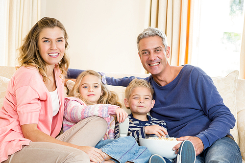 Happy family enjoying a movie together at home