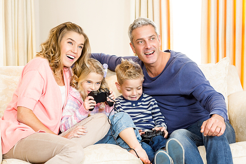 Happy family enjoying video games together at home