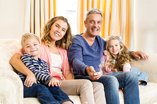 Happy family enjoying a movie together at home