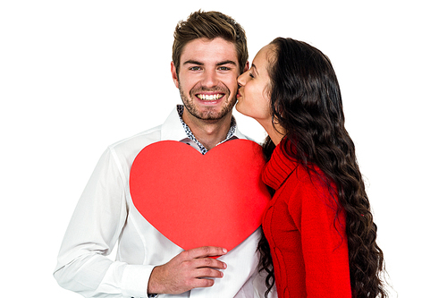 Man holding paper heart and being kissed by girlfriend on white screen