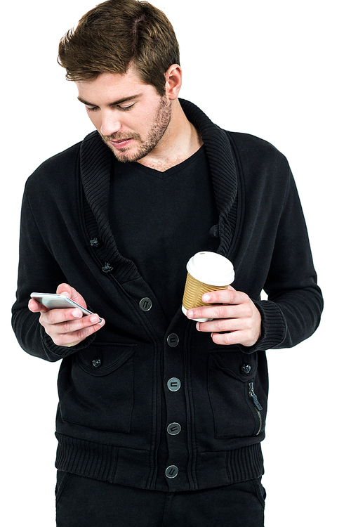 Handsome man using smartphone and holding disposable cup on white background