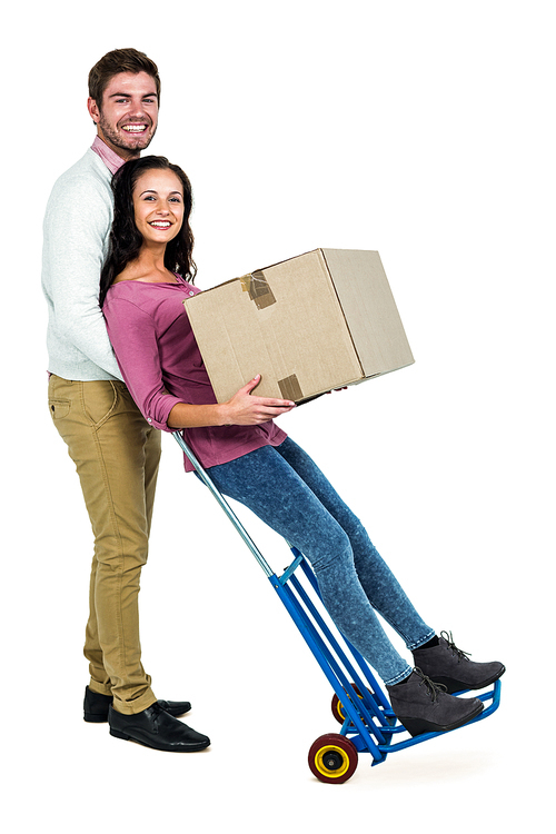 Smiling couple holding box on white screen