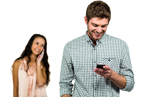 Smiling couple using smartphones over white background