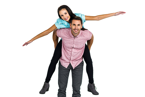 Smiling man with piggy back to his girlfriend on white screen
