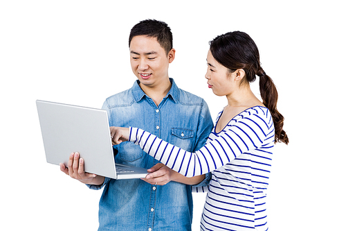 Couple using laptop against white background