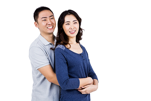 Cheerful couple embracing against white background