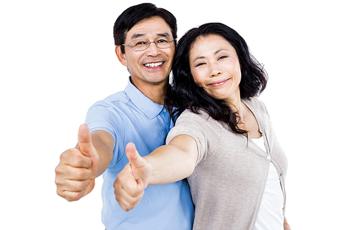 Couple standing together with thumbs up against white background