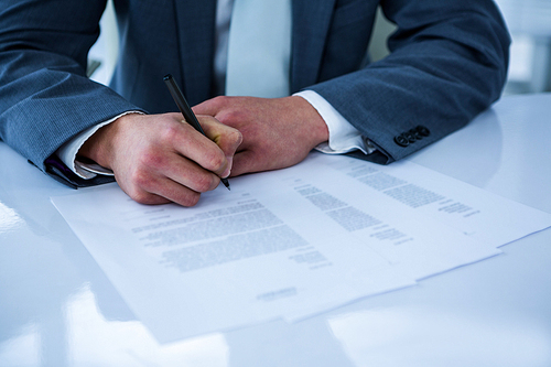 Businessman signing contract in a office