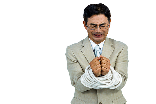 Asian businessman tied up in rope on white background