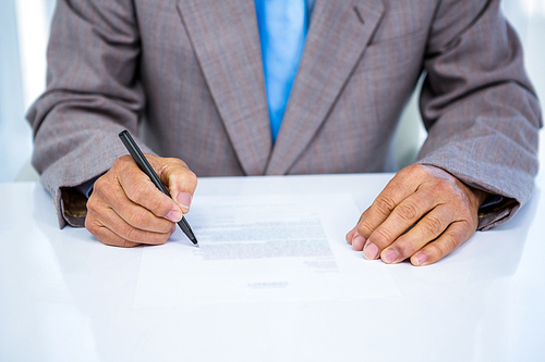 Serious businessman making notes in office