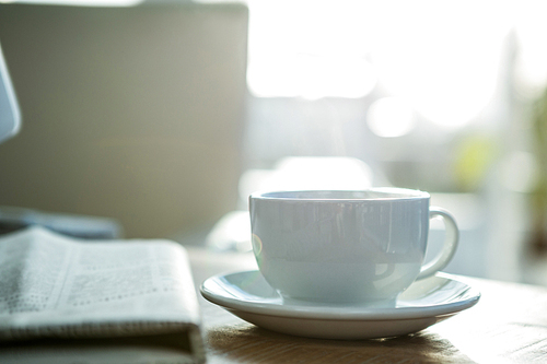 Steaming cup of coffee in office