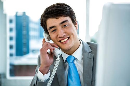 Businessman making a phone call in an office