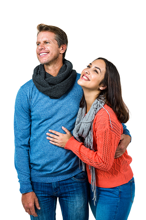 Smiling happy couple looking away against white background