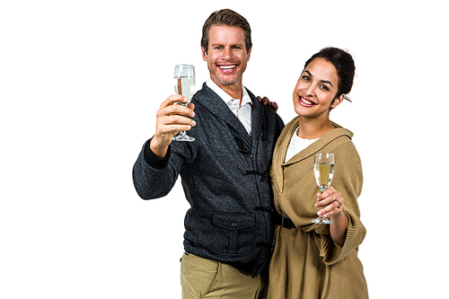 Portrait of dmiling couple holding wine glasses while standing on white background