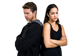 Angry couple standing back to back over white background