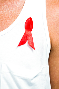 Aids awareness ribbon pinned on vest worn by man