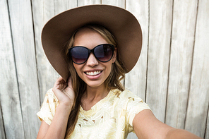 Young smiling women with glasses taking a selfie