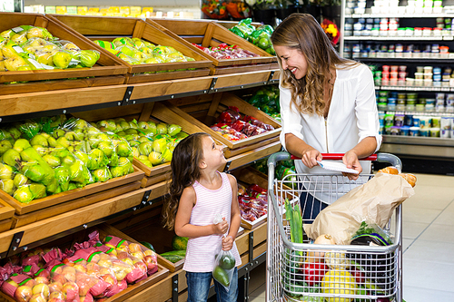 Mother and daughter doing shopping in grocery store