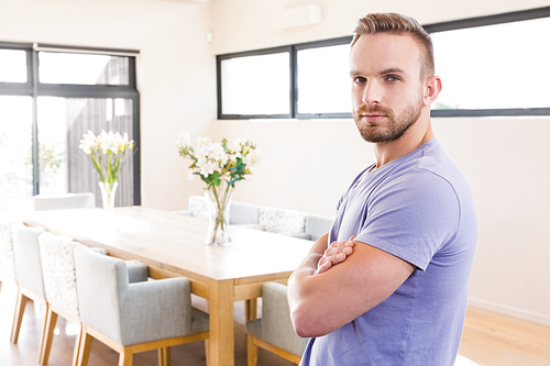 Handsome man with arms crossed in the living room