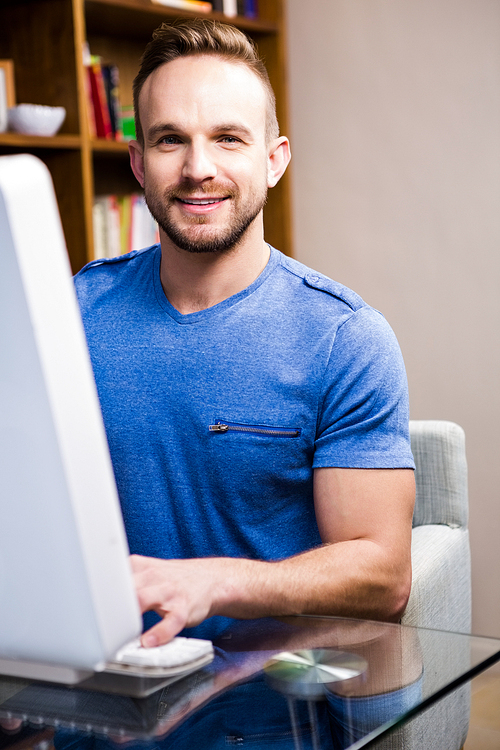 Smiling man using computer in the office