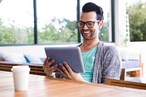 Smiling designer using tablet in the office