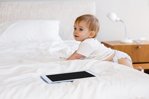 Cute baby climbing down the bed in bedroom