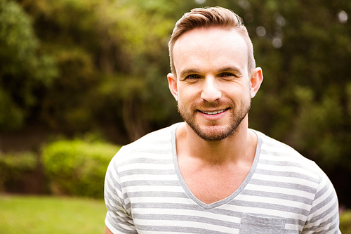 Smiling man posing for camera  in garden