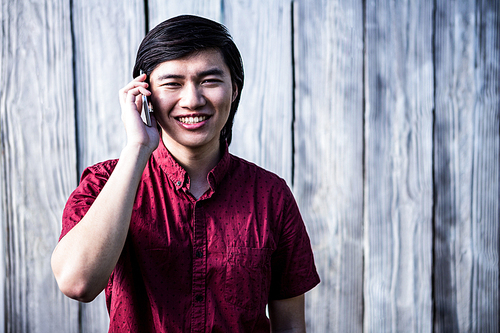 Hipster man on the phone on wooden background