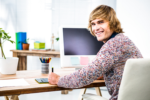 Side view of hipster businessman using tablet graphic in his office