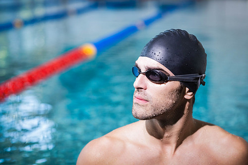 Upset man wearing swimming goggles at the pool