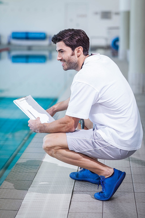 Trainer holding clipboard at the pool