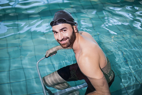 Focused man doing underwater bike in the pool