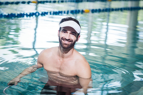 Smiling man doing underwater bike in the pool