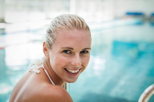 Attractive woman getting in the water at the pool