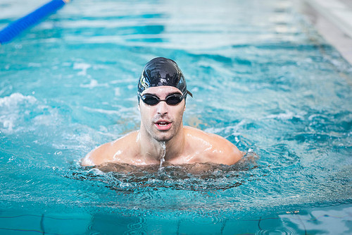 Handsome man swimming in the pool