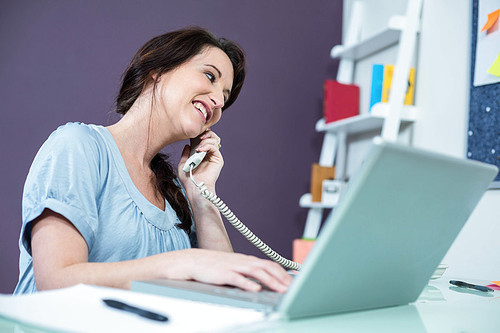 Pregnant woman on the phone at home