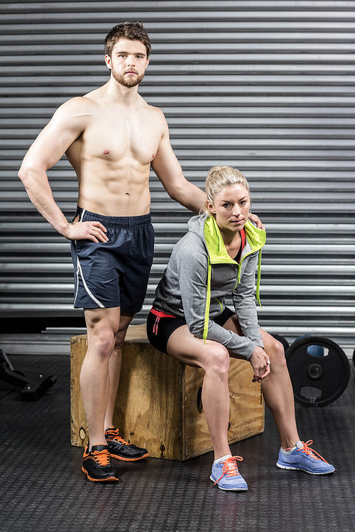 Portrait of serious athletic couple at crossfit gym