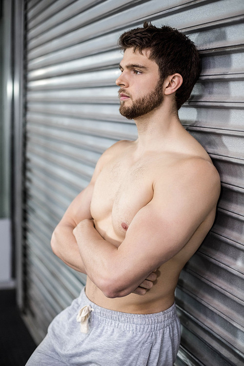 Shirtless fit man posing at crossfit gym
