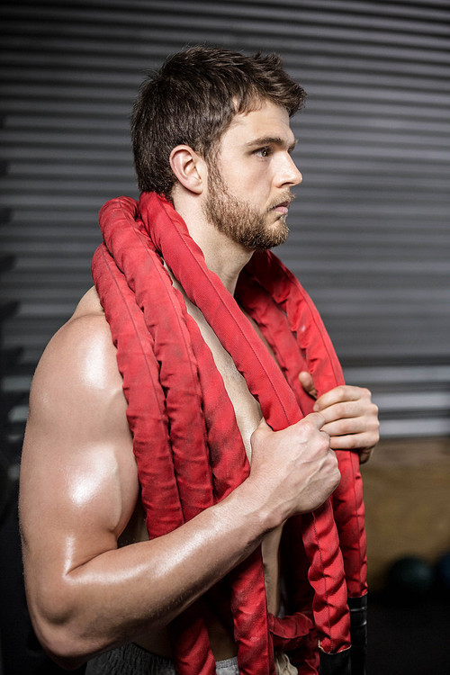 Man with rope around his neck at crossfit gym