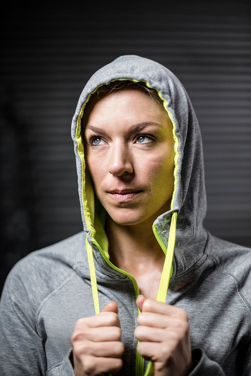 Portrait of woman wearing hood at crossfit gym