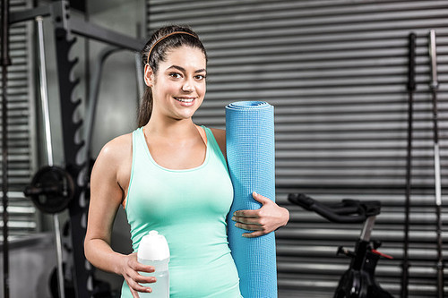 Athletic woman smiling to camera at crossfit gym