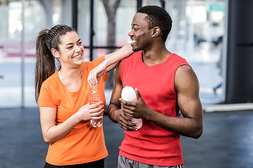 Smiling woman and man after effort at crossfit gym