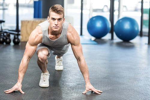 Athletic man smiling to camera at crossfit gym