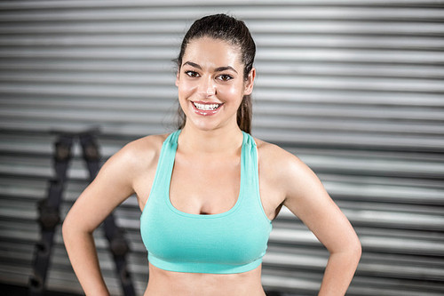 Portrait of smiling fit woman at crossfit gym